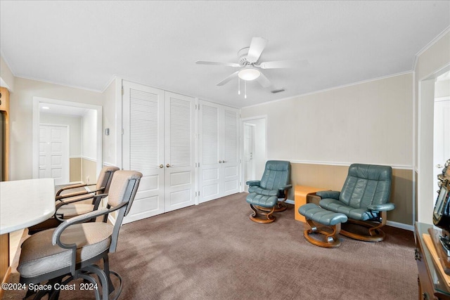 living area featuring ceiling fan, ornamental molding, and carpet floors