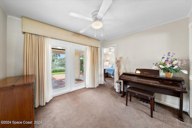 miscellaneous room featuring ceiling fan, carpet floors, and ornamental molding