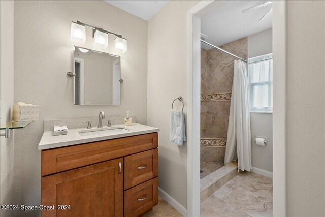 bathroom featuring ceiling fan, a shower with shower curtain, tile patterned flooring, and vanity