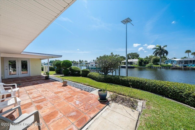 view of patio featuring french doors and a water view