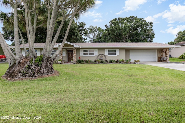 ranch-style home with a front yard and a garage