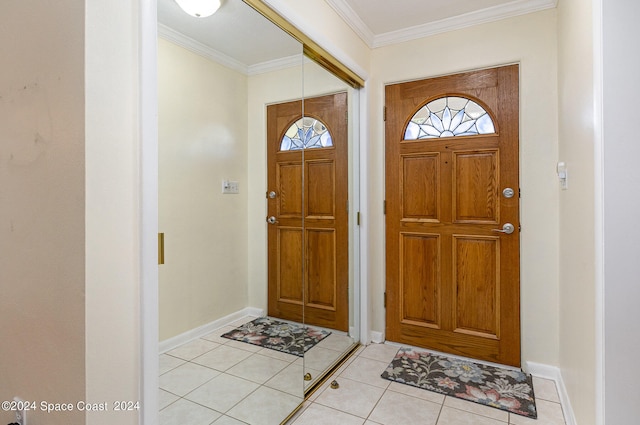 tiled entryway featuring crown molding