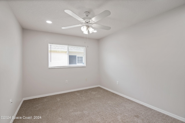 spare room with ceiling fan and carpet floors