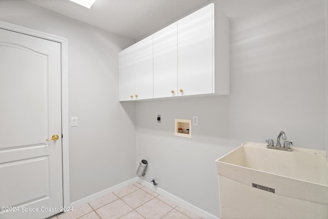 laundry room featuring washer hookup, cabinets, hookup for an electric dryer, light tile patterned floors, and sink