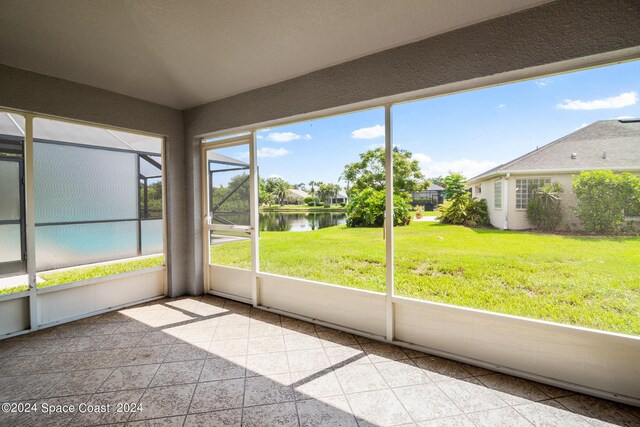 unfurnished sunroom with a water view