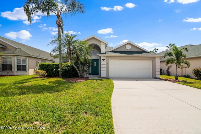 ranch-style house featuring a garage and a front yard