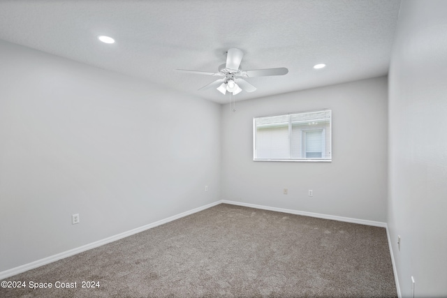 spare room featuring ceiling fan and carpet flooring