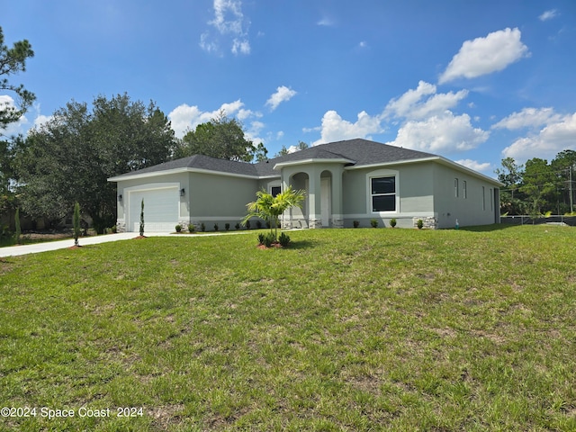 view of front of property featuring a garage and a front lawn