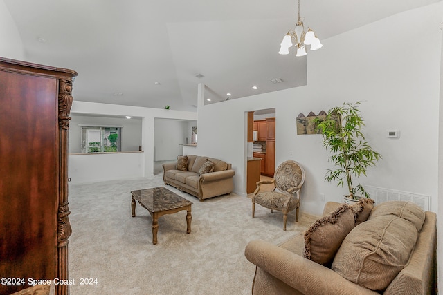 living room featuring high vaulted ceiling, light carpet, and an inviting chandelier