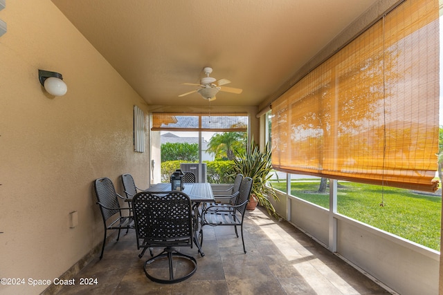 sunroom featuring ceiling fan and a healthy amount of sunlight