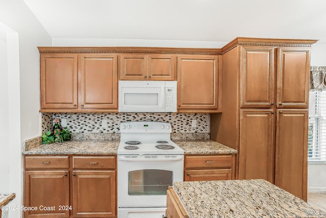 kitchen with tasteful backsplash and white appliances