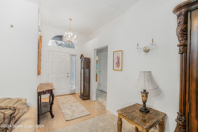 tiled foyer with a chandelier