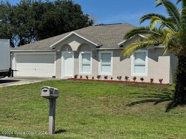 ranch-style house with stucco siding, a shingled roof, concrete driveway, a garage, and a front lawn