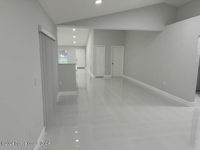 spare room with lofted ceiling, baseboards, and recessed lighting