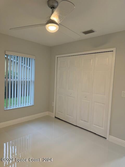 unfurnished bedroom featuring a closet, visible vents, ceiling fan, and baseboards