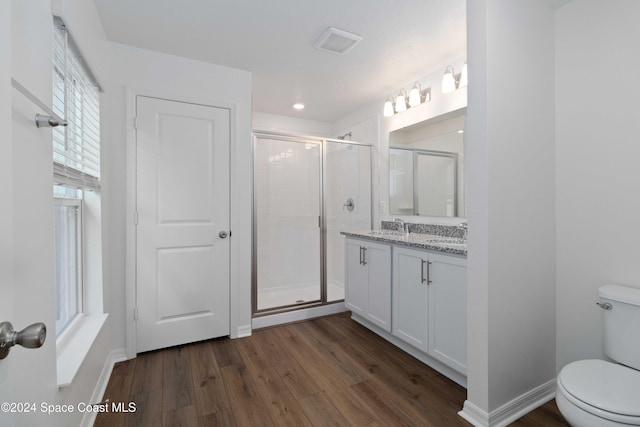 bathroom with walk in shower, toilet, vanity, and hardwood / wood-style flooring