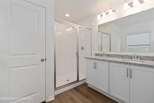 bathroom featuring vanity, an enclosed shower, and hardwood / wood-style flooring