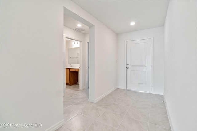 corridor with light tile patterned flooring