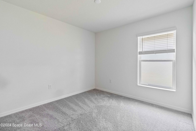 3480 Aramore Rd SE, Palm Bay, FL 32909 - carpeted empty room featuring baseboards