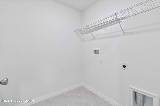 laundry area featuring electric dryer hookup, washer hookup, and light tile patterned floors