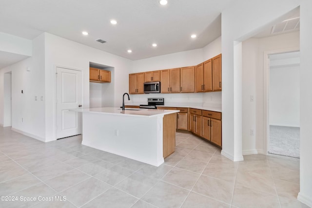 3480 Aramore Rd SE, Palm Bay, FL 32909 - kitchen with brown cabinets, stainless steel appliances, visible vents, and a sink