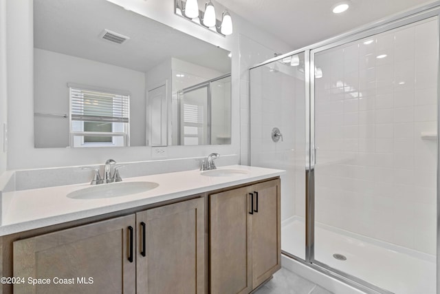 3480 Aramore Rd SE, Palm Bay, FL 32909 - bathroom with double vanity, visible vents, a stall shower, and a sink