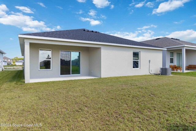 back of property with a yard, a patio, and cooling unit