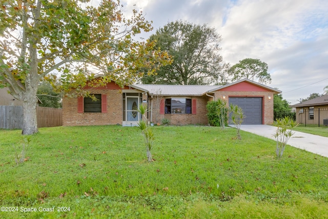 single story home with a front lawn and a garage