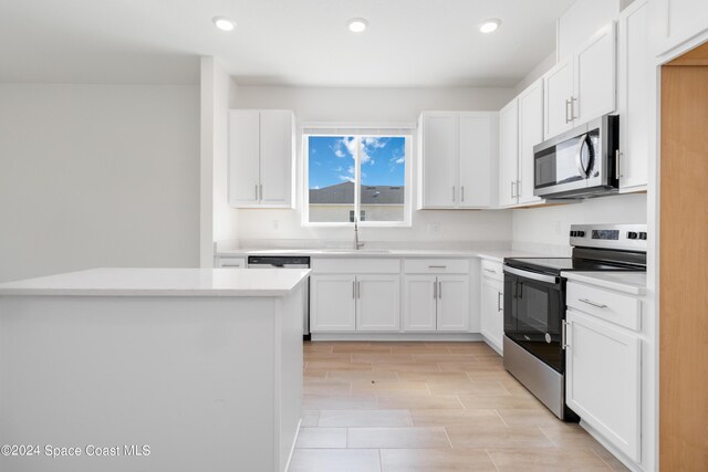 kitchen featuring white cabinetry, stainless steel appliances, and sink