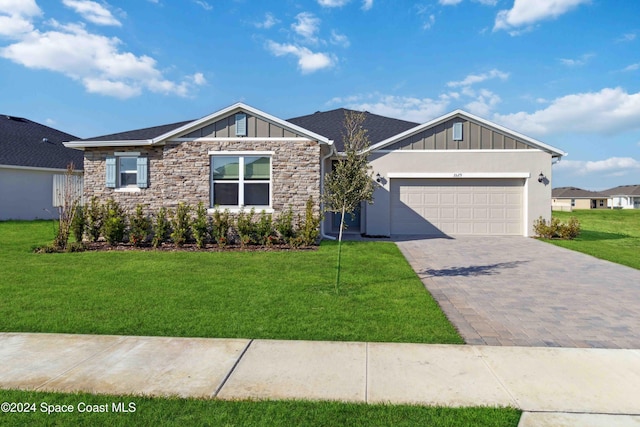 view of front of house with a garage and a front lawn