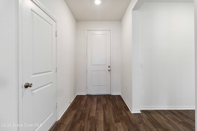 hallway with dark hardwood / wood-style flooring