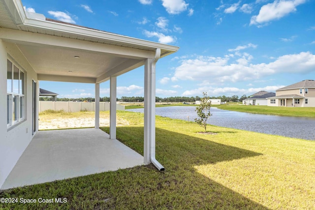 view of yard with a patio area and a water view