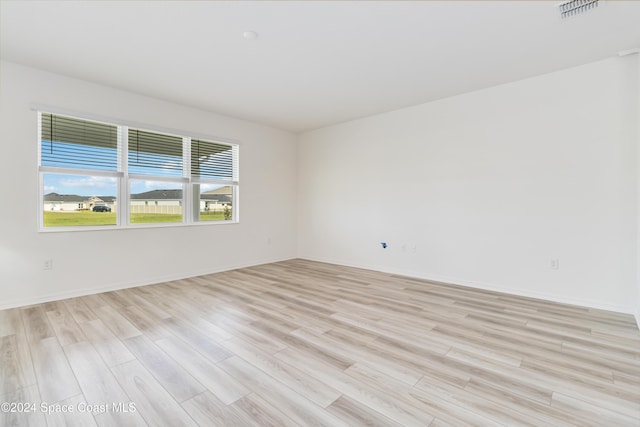 unfurnished room with light hardwood / wood-style flooring