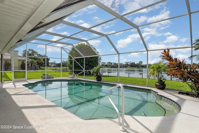 view of pool featuring glass enclosure, a patio area, and a lawn