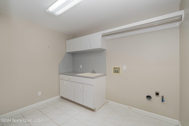 clothes washing area featuring light tile patterned flooring, washer hookup, hookup for an electric dryer, and cabinets