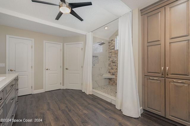 bathroom featuring ceiling fan, hardwood / wood-style floors, vanity, and walk in shower