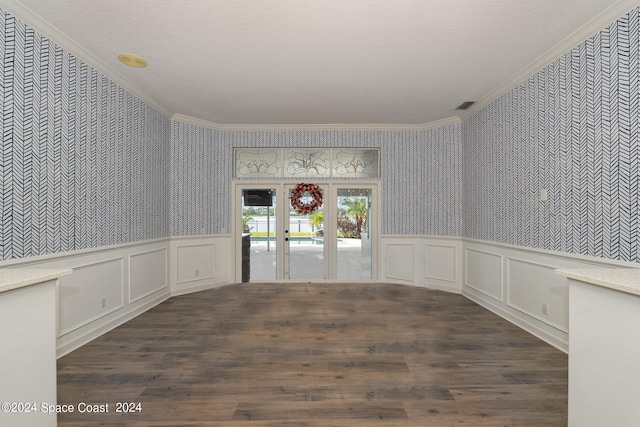 empty room with hardwood / wood-style flooring, french doors, and crown molding