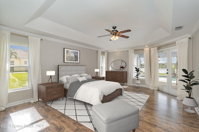 bedroom with light hardwood / wood-style flooring, ceiling fan, a raised ceiling, and access to outside