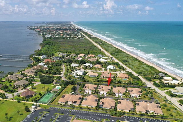 birds eye view of property with a beach view and a water view