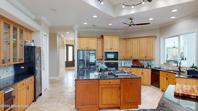 kitchen featuring ceiling fan, decorative backsplash, a kitchen island, light tile patterned floors, and black appliances