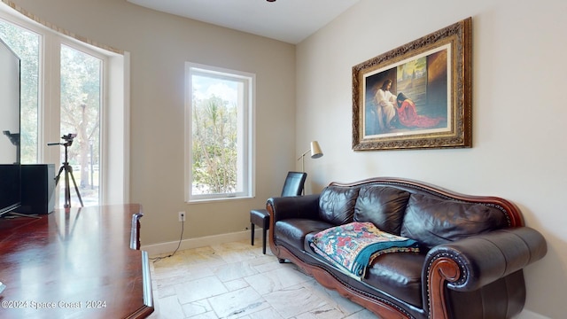 tiled living room featuring a wealth of natural light