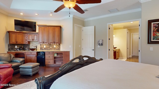 bedroom with ceiling fan, crown molding, and connected bathroom