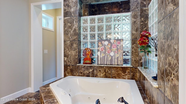 bathroom with tile patterned floors and tiled bath