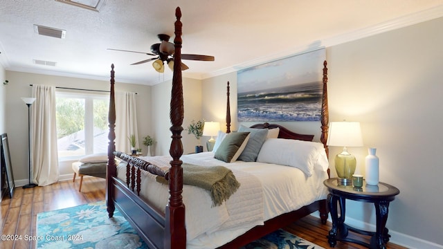 bedroom featuring light hardwood / wood-style floors, ornamental molding, ceiling fan, and a textured ceiling