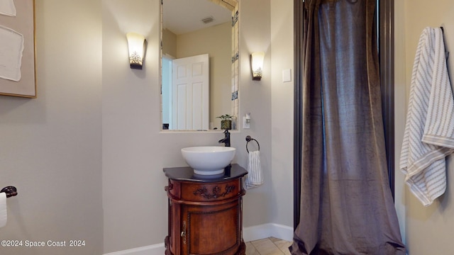 bathroom with tile patterned flooring and vanity