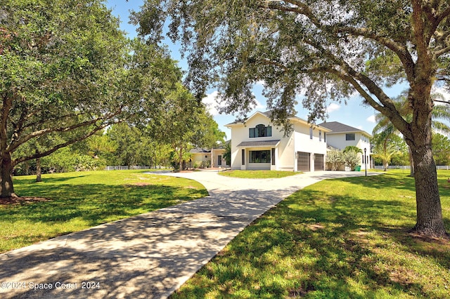 view of front of property featuring a garage and a front yard