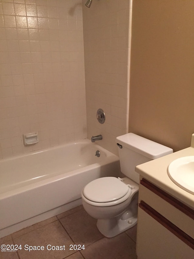 full bathroom featuring tile patterned flooring, vanity, toilet, and tiled shower / bath combo