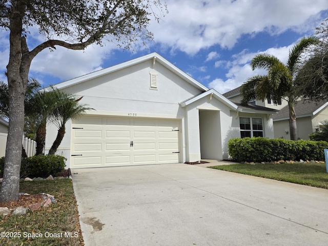 ranch-style home featuring a garage, concrete driveway, and stucco siding