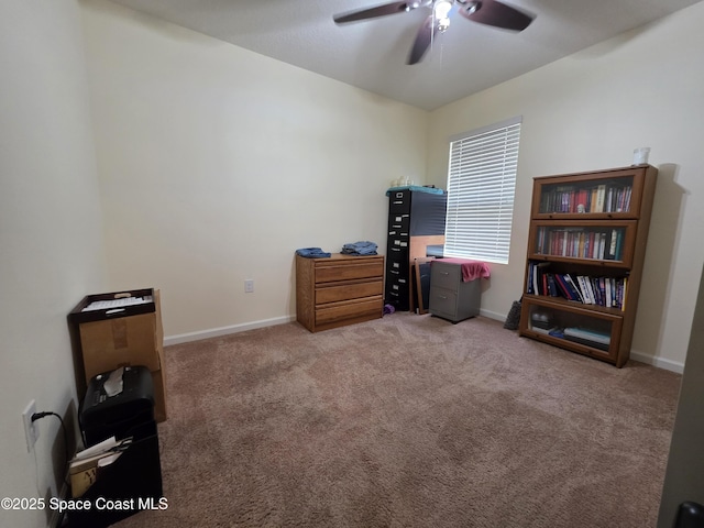 miscellaneous room with carpet floors, baseboards, and a ceiling fan