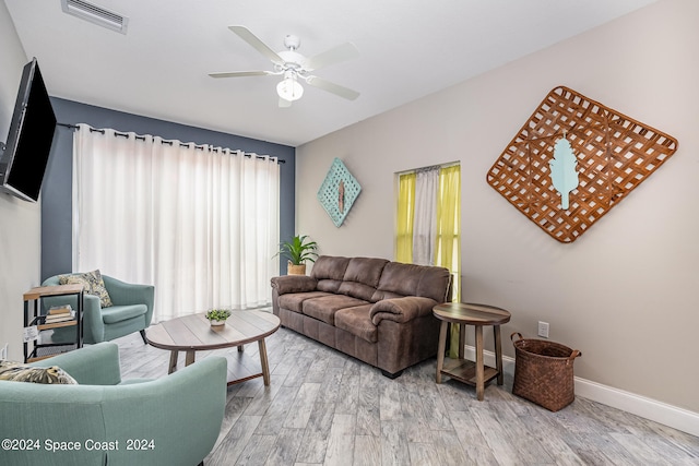 living room with ceiling fan and wood-type flooring